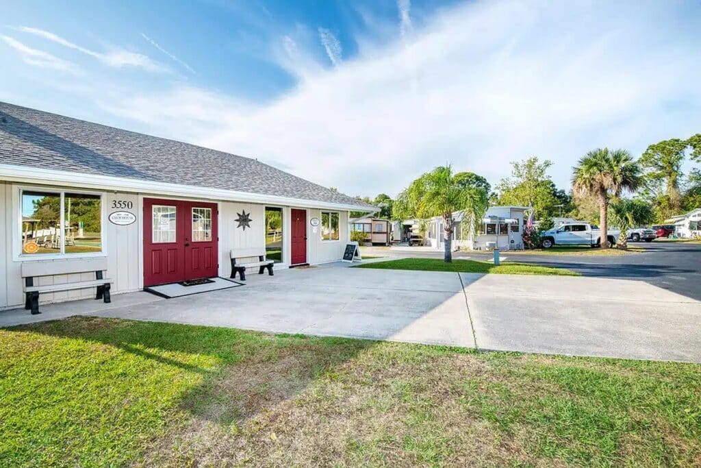 Front view of Holiday Village RV Park featuring a welcoming red door, showcasing the park's inviting atmosphere.