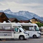 Three RVs stationed at a scenic site, perfect for travelers exploring the outdoors.