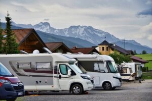 Three RVs stationed at a scenic site, perfect for travelers exploring the outdoors.